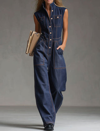 Dark blue denim women's sleeveless balloon jumpsuit with multiple pockets and wide-leg pants, featuring a relaxed fit and casual style.