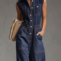 Dark blue denim sleeveless balloon jumpsuit with multiple pockets, designed for women, featuring a relaxed fit and stylish details.