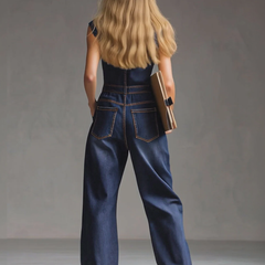 Dark blue denim sleeveless jumpsuit with multiple pockets, balloon pants style for women, featuring a relaxed fit and casual design.
