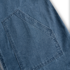Casual women's denim jumpsuit with long sleeves, hood, zipper, and retro pocket details, featuring a loose fit and stylish design.