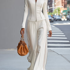 White stand collar zip-up wide-leg women's trouser suit with tailored pants and matching top, stylish and modern ensemble.