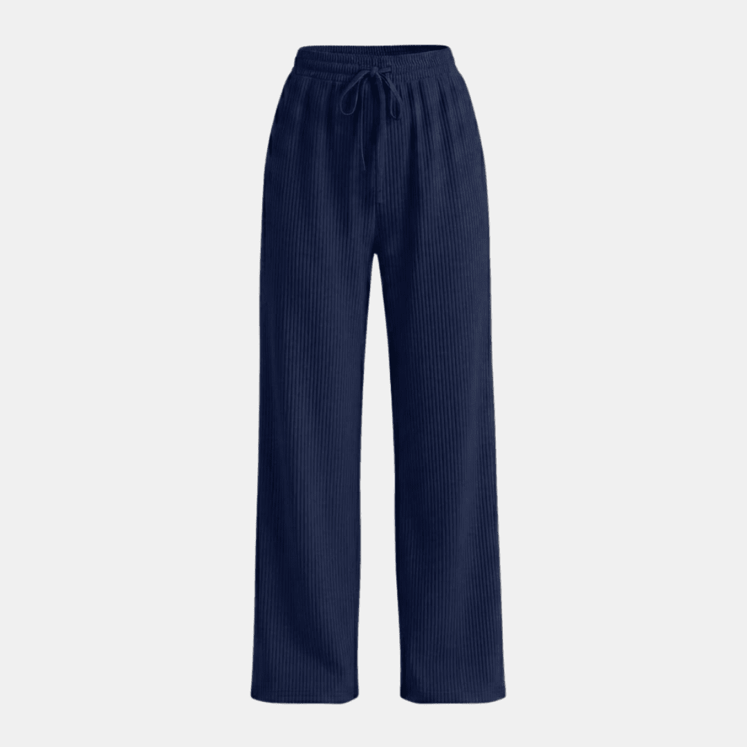 Women’s plissé wide-leg trousers by Tammy Bradley, featuring lightweight, flowing fabric and a relaxed fit in a stylish design.