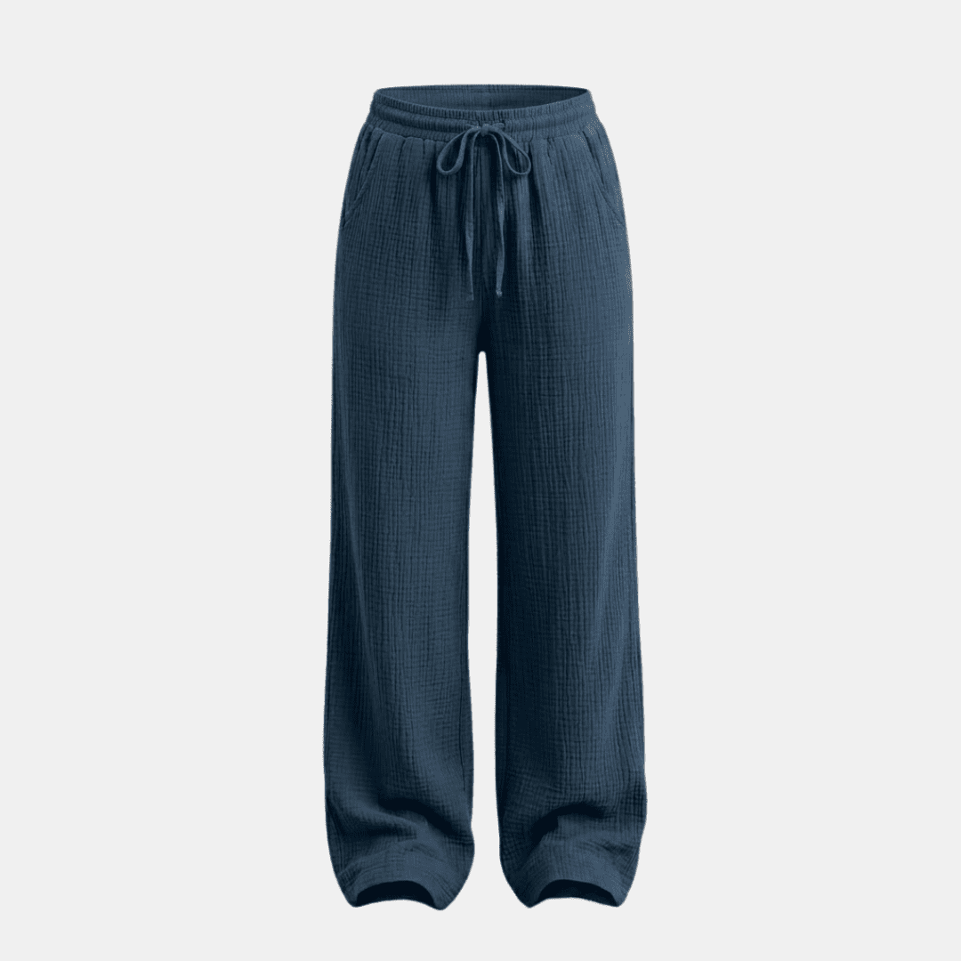 Women's cotton wide-leg trousers by Tammy Bradley, showing the relaxed fit and smooth fabric in a neutral color.