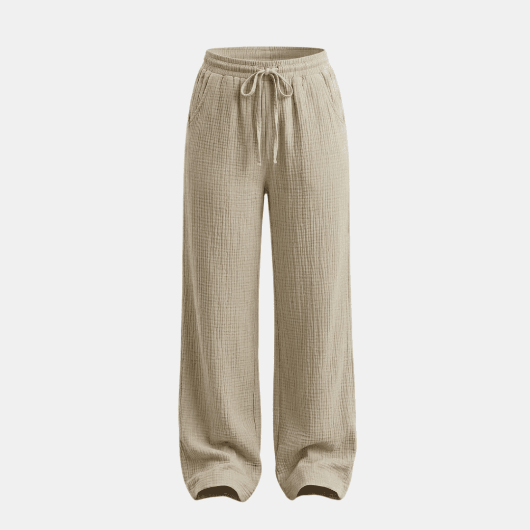 Women's cotton wide-leg trousers by Tammy Bradley, shown in a relaxed fit with a high waist and flowing fabric.