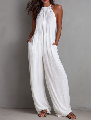 White pleated halter neck wide-leg resort jumpsuit for women, featuring stylish pants with a relaxed fit and elegant design.
