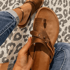 Open-toe women's orthopedic sandals with a heel, stylishly designed for comfort and support, featuring a sleek strap and cushioned sole.