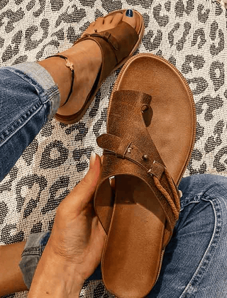 Open-toe women's orthopedic sandals with a heel, stylishly designed for comfort and support, featuring a sleek strap and cushioned sole.