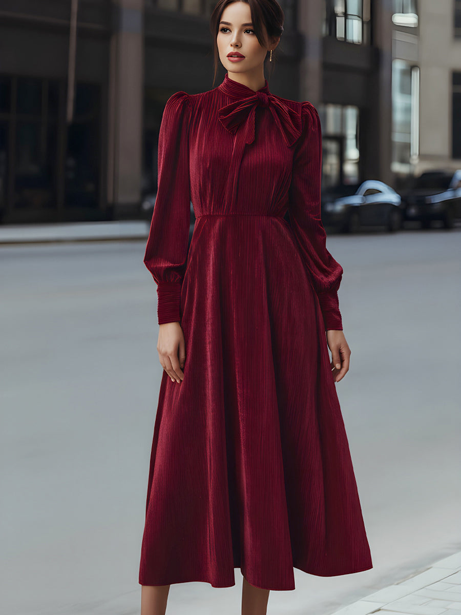 Burgundy velvet pleated bow-neck midi dress, elegant cocktail dress with a fitted waist and flowing skirt.