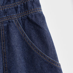 Dark blue denim sleeveless balloon jumpsuit with multiple pockets, designed for women, featuring a relaxed fit and stylish silhouette.