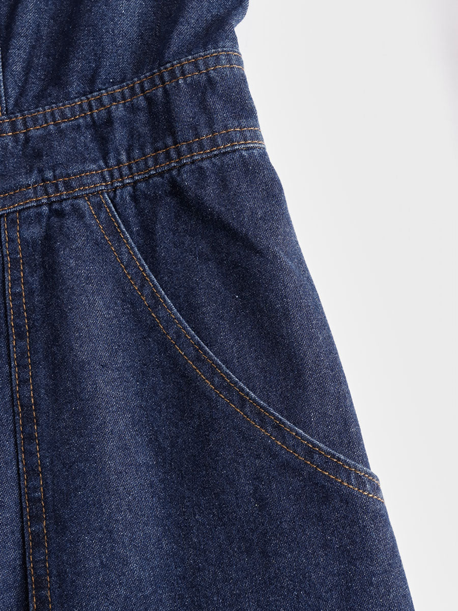 Dark blue denim sleeveless balloon jumpsuit with multiple pockets, designed for women, featuring a relaxed fit and stylish silhouette.