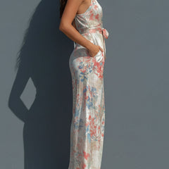 White floral satin halter neck jumpsuit with wrap front and wide-leg pants for women, stylish and elegant.