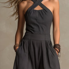 Charcoal pinstripe halter neck wide-leg jumpsuit for women, featuring a stylish design with a fitted waist and flowing pant legs.