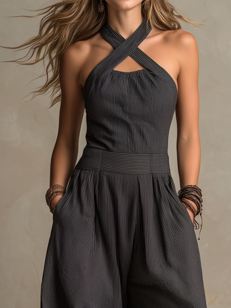Charcoal pinstripe halter neck wide-leg jumpsuit for women, featuring a stylish design with a fitted waist and flowing pant legs.
