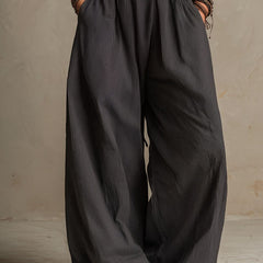 Charcoal pinstripe halter neck wide-leg jumpsuit for women, stylish pants by My Store, featuring a halter neckline and relaxed fit.