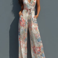 White floral satin halter neck wide-leg jumpsuit for women, featuring a wrap front design and elegant style.