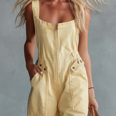 Light yellow denim women's jumpsuit with square neckline and front zipper, featuring pant-style design and long sleeves.