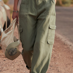Green multi-pocket cargo trousers for women with multiple functional pockets, relaxed fit, and casual style.