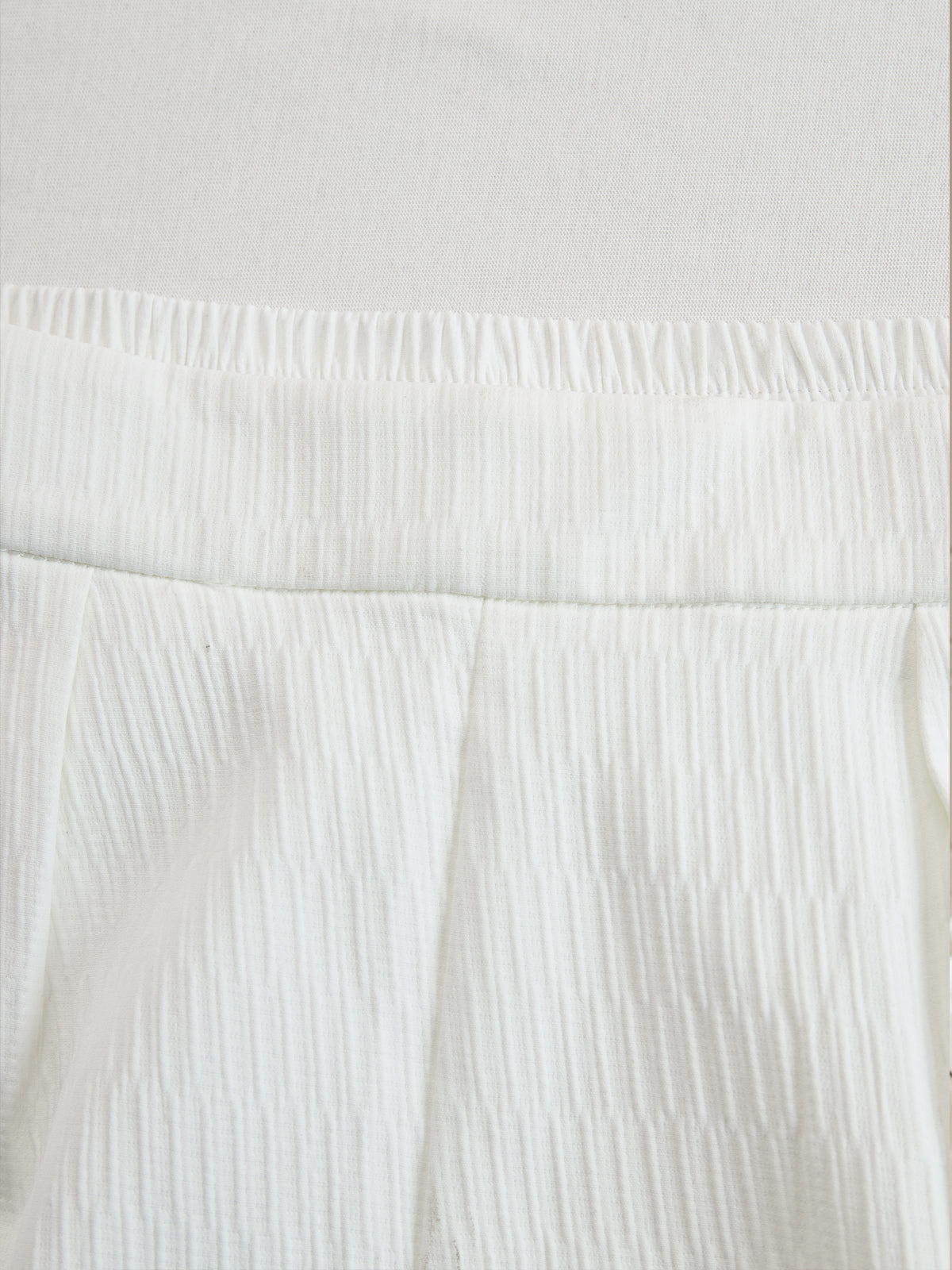 Cream textured lantern sleeve two-piece set for women, featuring stylish pants and a matching top with unique sleeve design.
