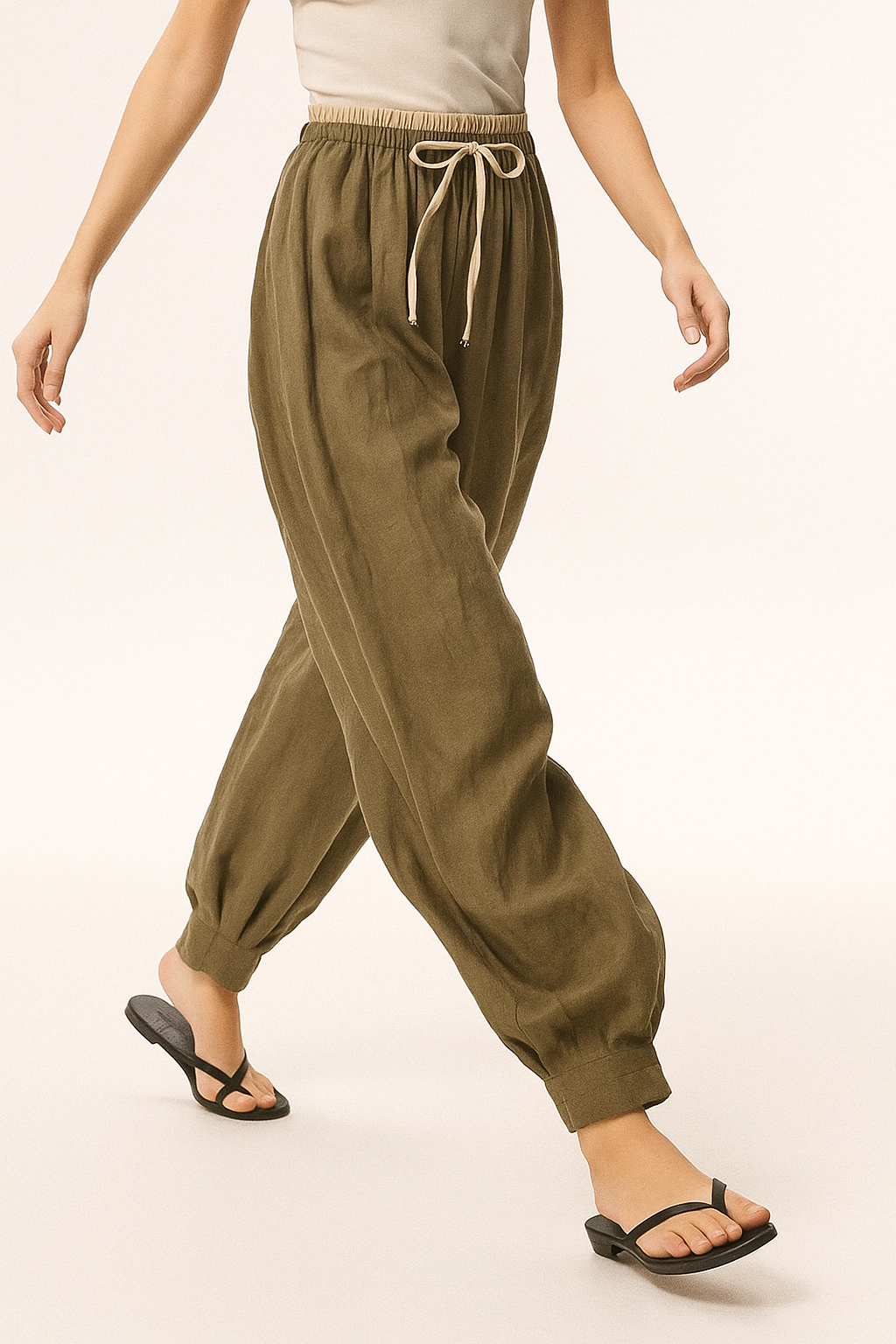 Light beige tapered linen trousers for women, loose pull-on style, casual pants with relaxed fit and comfortable waistband.