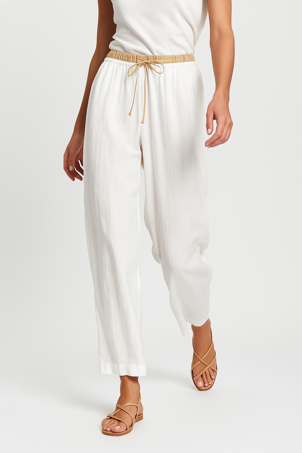 Beige tapered linen trousers for women with a loose, pull-on style and relaxed fit, perfect for casual or summer wear.