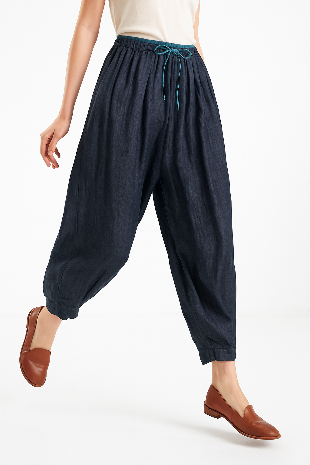 Beige tapered linen trousers for women, loose pull-on pants, stylish and comfortable casual wear, displayed on a model.