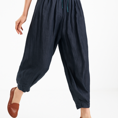 Tapered linen trousers for women, loose pull-on style, beige color, stylish and comfortable casual pants.