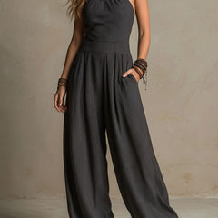 Charcoal pinstripe women's halter neck wide-leg jumpsuit with pants style, featuring a stylish halter top and relaxed fit.