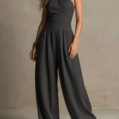 Charcoal pinstripe halter neck wide-leg jumpsuit for women, stylish and comfortable pants, featuring a halter neckline and relaxed fit.