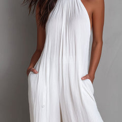 White pleated halter neck wide-leg resort jumpsuit for women, featuring stylish design and comfortable fit.