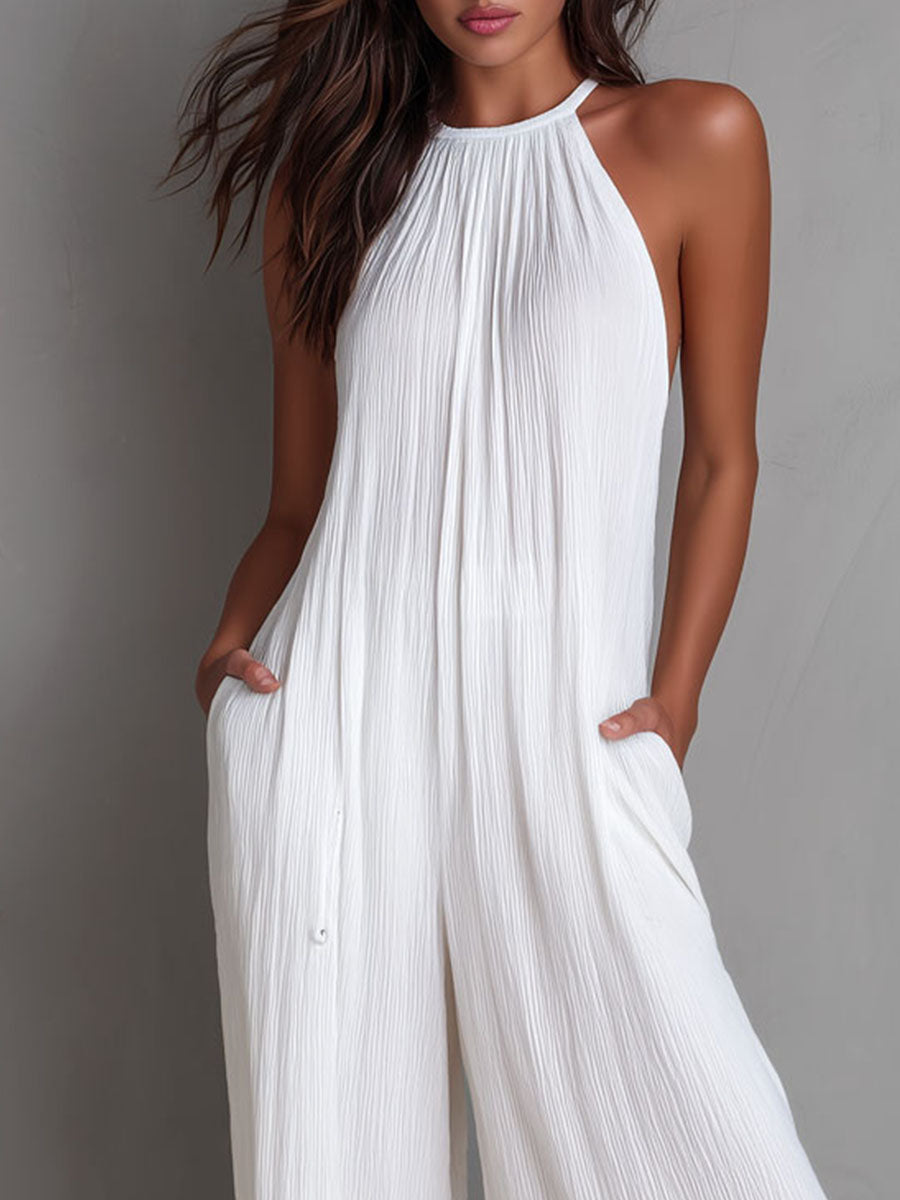 White pleated halter neck wide-leg resort jumpsuit for women, featuring stylish design and comfortable fit.