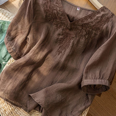 Light blue V-neck linen summer blouse for women, flowy and casual, stylish top perfect for warm weather.