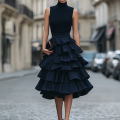 Sleeveless high neck tiered ruffle midi dress in soft fabric, featuring layered ruffle details and a stylish high neckline.