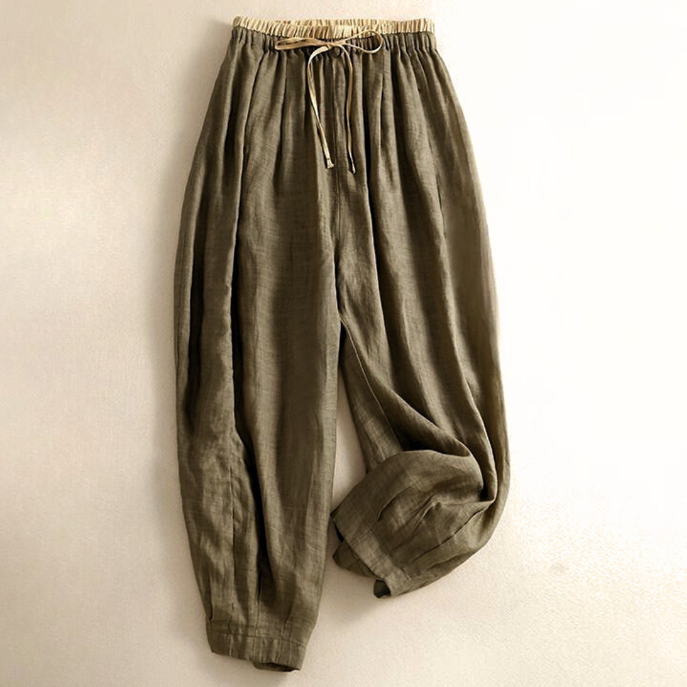 Light beige tapered linen trousers for women with a loose fit and pull-on style, showcasing comfortable, casual pants.
