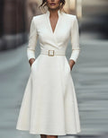 Gold V-neck A-line midi dress for women with three-quarter sleeves by Tammy Bradley, shown on a model.