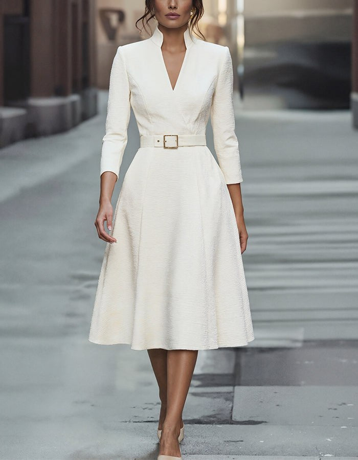 Gold V-neck A-line midi dress for women with three-quarter sleeves by Tammy Bradley, shown hanging on a mannequin.