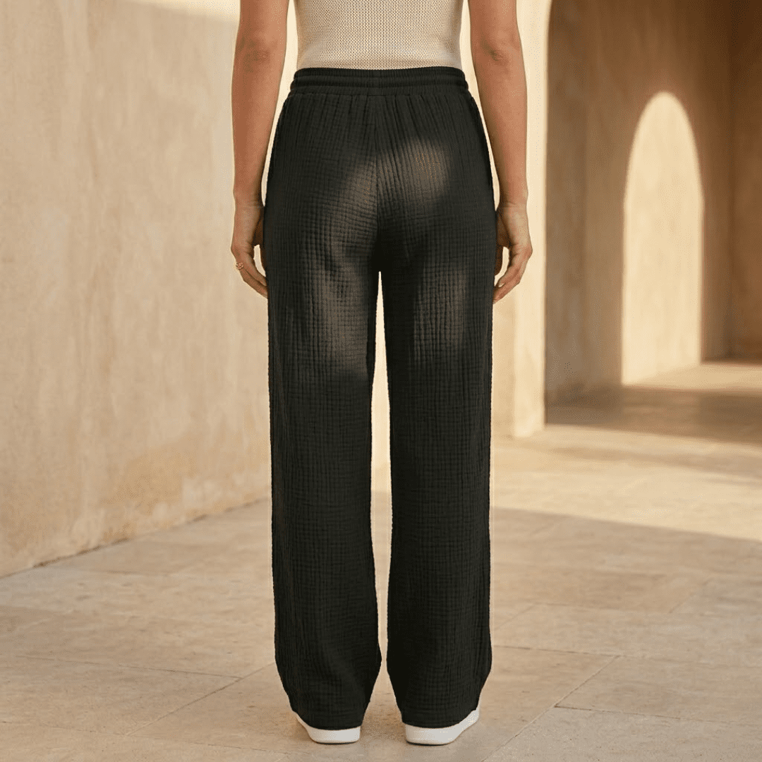 Women's cotton wide-leg trousers by Tammy Bradley, featuring a relaxed fit and classic wide-leg style in a casual fabric.