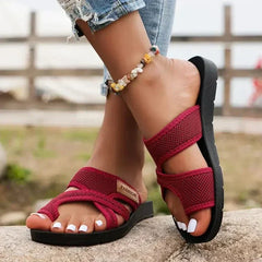 Open-toe orthopedic slippers for women with a heeled design, featuring cushioned soles and supportive structure for comfortable wear.