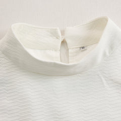 Cream textured lantern sleeve two-piece set for women, including stylish pants and top, featuring unique lantern sleeves.