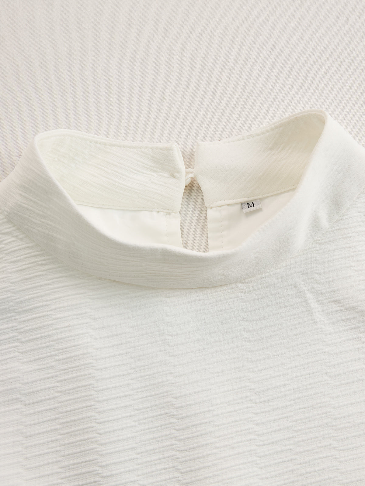 Cream textured lantern sleeve two-piece set for women, including stylish pants and top, featuring unique lantern sleeves.