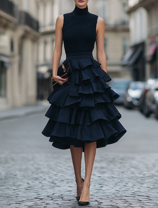 Sleeveless high neck tiered ruffle midi dress in soft fabric, featuring layered ruffles and a flowy silhouette.