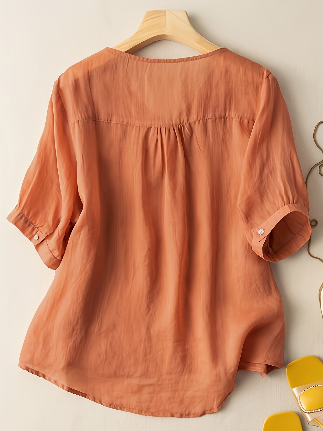 Light beige women's summer blouse with V-neck and flowy linen fabric, casual and stylish for warm weather.