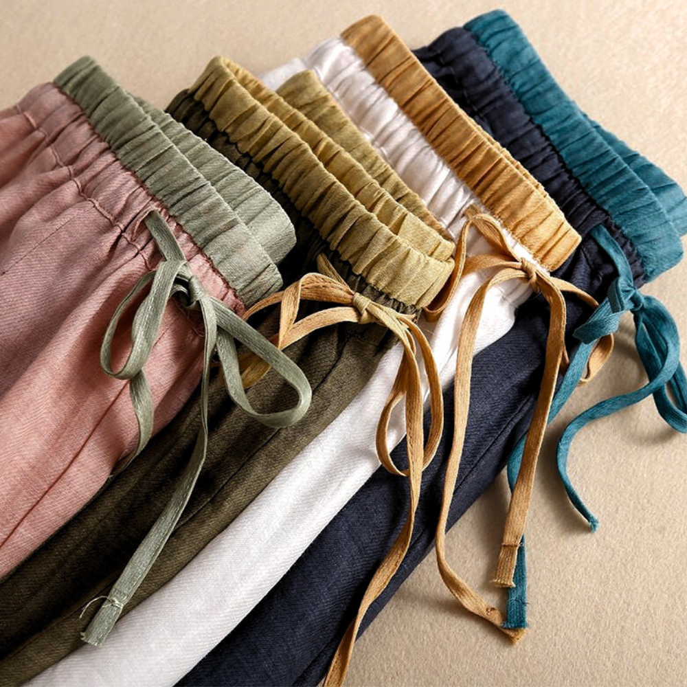 Light beige tapered linen trousers for women, loose pull-on style, casual and comfortable pants for everyday wear.