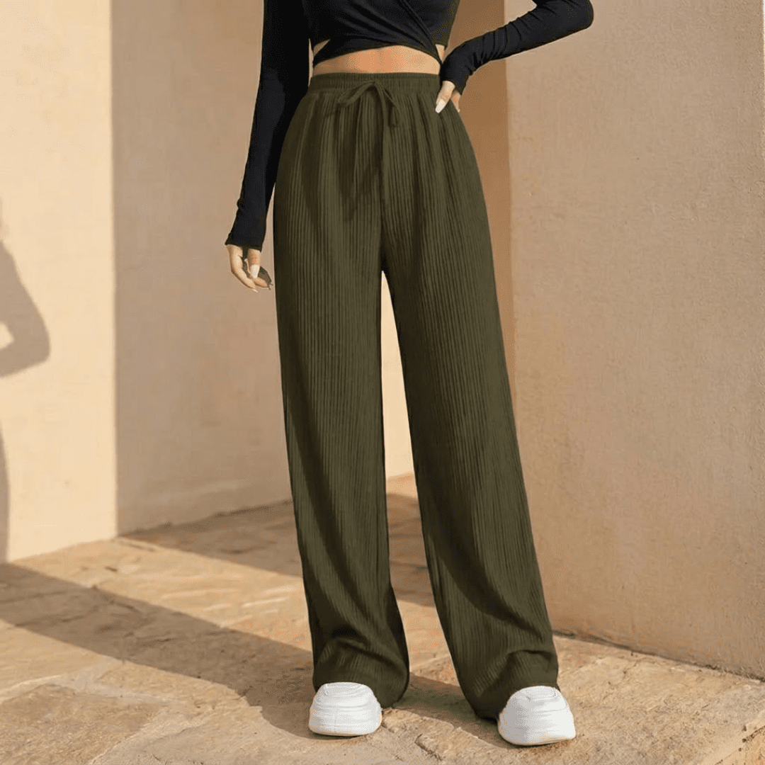 Women's plissé wide-leg trousers by Tammy Bradley, featuring flowing fabric and a relaxed fit for casual or dressy wear.