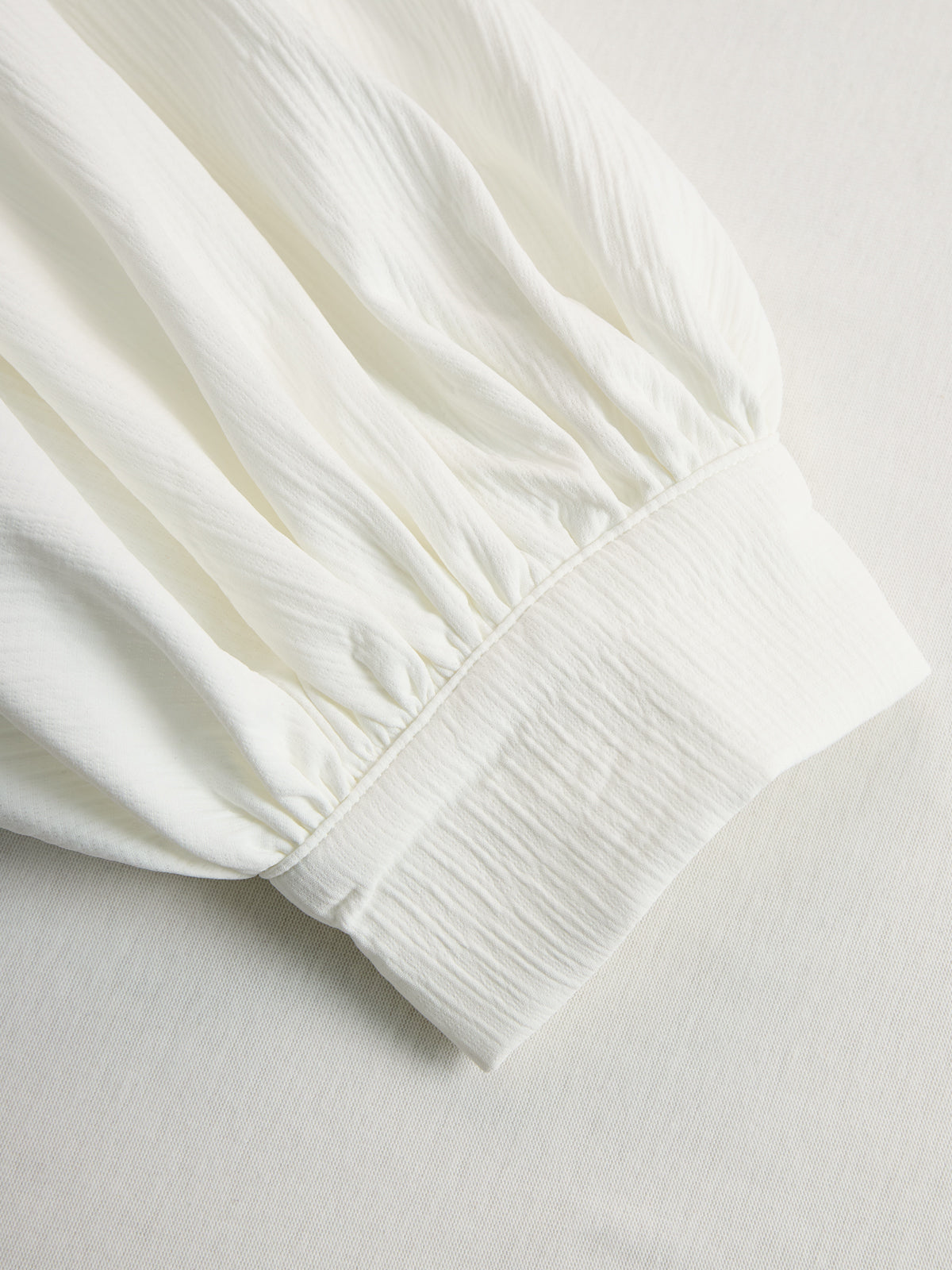 Cream textured lantern sleeve two-piece pants set for women, featuring stylish lantern sleeves and comfortable fit.