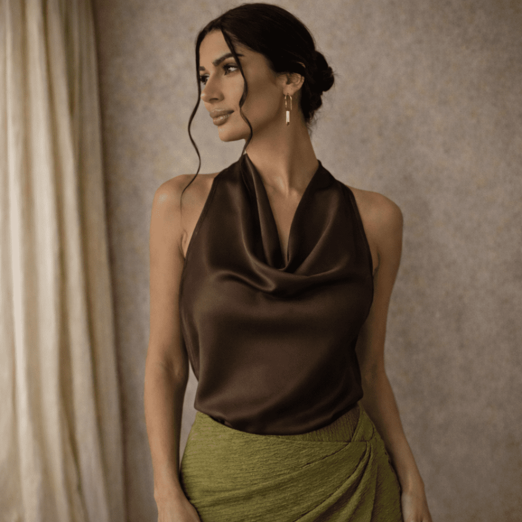 Cream satin cowl-neck sleeveless top for women by Tammy Bradley, shown on a model with elegant drape and smooth fabric.