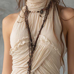 Ivory pleated halter neck chiffon sleeveless blouse for women with a stylish, flowy design and elegant pleats.