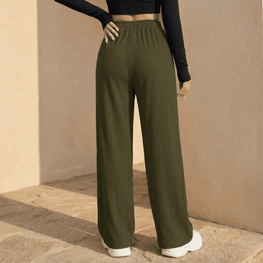 Women's plissé wide-leg trousers by Tammy Bradley, featuring flowing fabric and high-waisted design, shown in a stylish full-length view.
