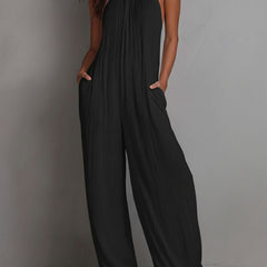 White pleated halter neck wide-leg resort jumpsuit for women, featuring stylish pants and a relaxed fit.
