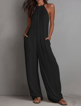 White pleated halter neck wide-leg resort jumpsuit for women, featuring stylish pants and a relaxed fit.