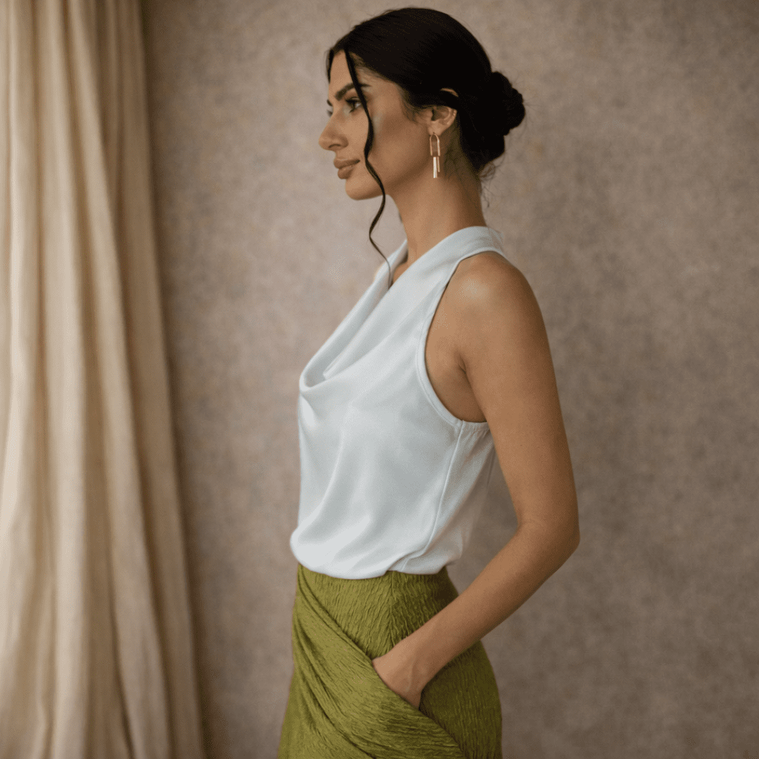 Cream satin cowl-neck sleeveless top for women by Tammy Bradley, smooth fabric with elegant drape and a stylish cowl neckline.